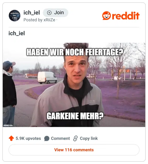 Ein virales Meme aus dem Subreddit ich_iel. Zu sehen ist ein junger Mann, der leicht verzweifelt in die Kamera blickt. Der obere Text lautet: „HABEN WIR NOCH FEIERTAGE?“ – darunter: „GARKEINE MEHR?“ Im Hintergrund: ein Parkplatz mit Lieferwagen und herbstlich kahlen Bäumen, das Gras ist digital verfremdet in einem unnatürlichen Lila-Ton eingefärbt. Das Meme spielt humorvoll mit der kollektiven Erschöpfung nach der letzten freien Woche im Jahr.