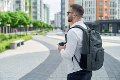 Mann trägt einen Rucksack und ist gerade auf dem Weg zur Arbeit.