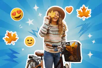 Eine lächelnde Frau mit Hut und Fahrrad im Herbst, umgeben von herbstlichen Blättern und positiven Emojis auf blauem Hintergrund.