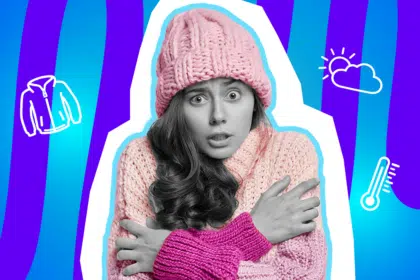 Humorvolle Collage einer frierenden Frau in Schwarz-Weiß, die eine rosa Strickmütze und einen dicken, rosa-pinken Pullover trägt. Sie hält sich fröstelnd die Arme, umgeben von weißen Icons einer Übergangsjacke, einer Wolke mit Sonne und einem Thermometer. Der Hintergrund ist blau-violett gestreift und thematisiert die wechselhaften Temperaturen im Frühling und Herbst.